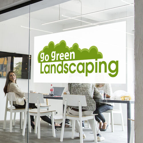 Custom perforated window decal applied to a storefront glass window showing a clear, bubble-free installation.